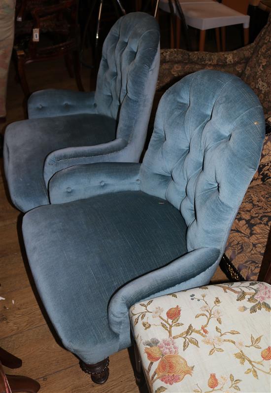 A pair of blue upholstered buttonback nursing chairs
